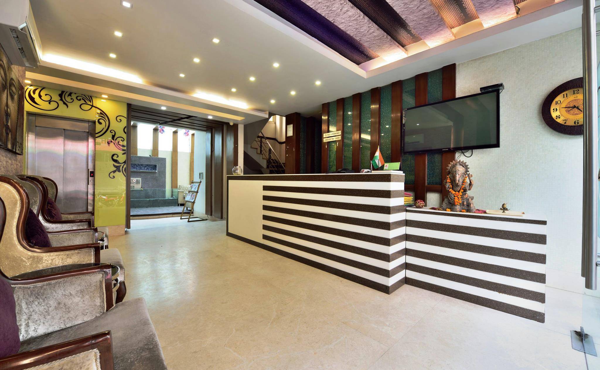 Deluxe AC Room — neatly arranged bed and modern furnishings